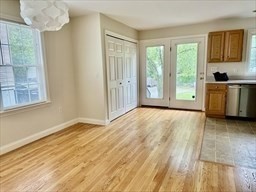 a view of a room with wooden floor and a window
