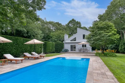 a swimming pool with outdoor seating and yard