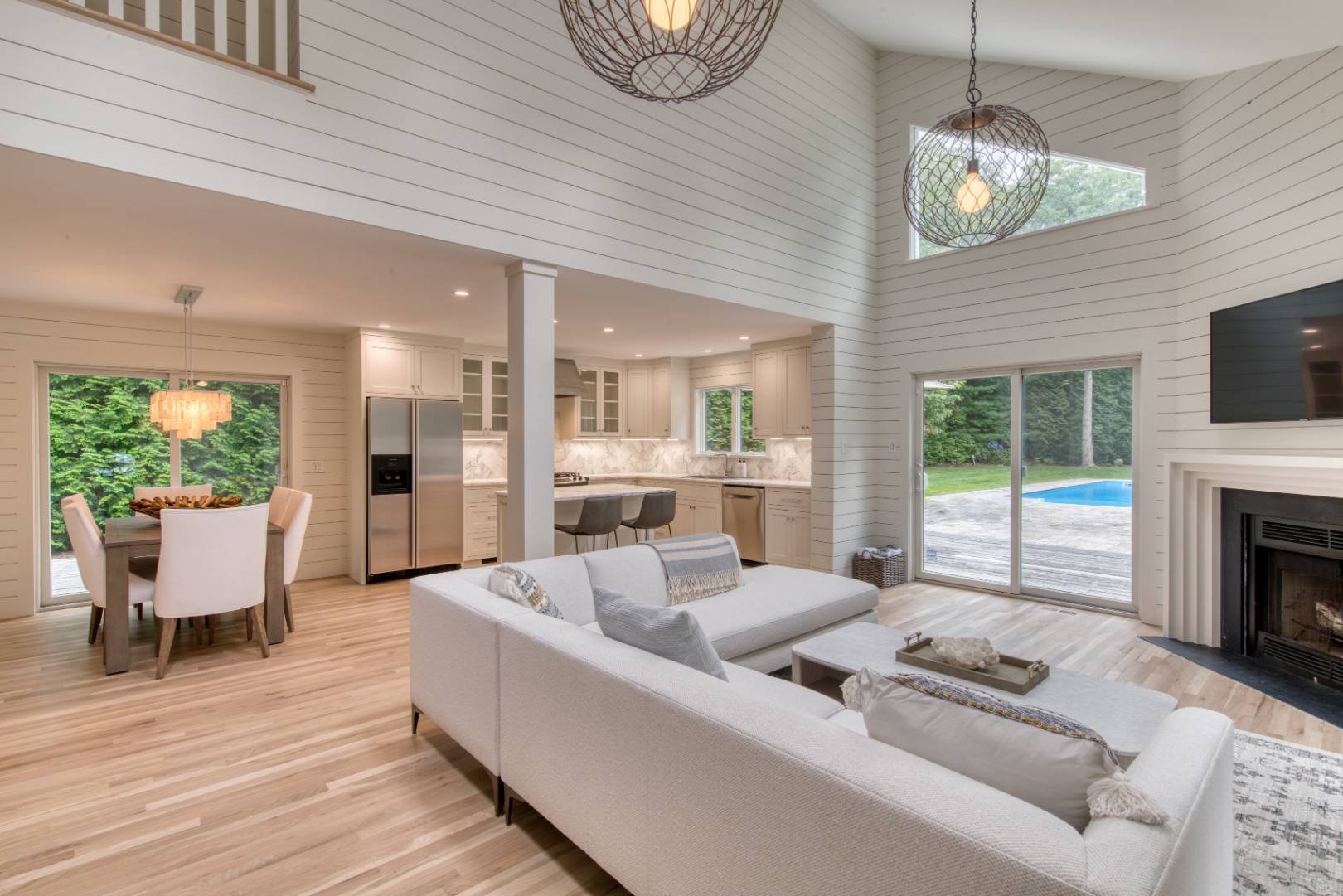 3 Short Lane East Hampton, NY 11937 - Photo 2 of 13 a living room with furniture a fireplace and a flat screen tv