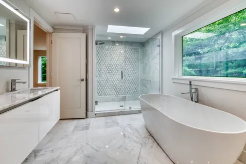a spacious bathroom with a tub shower and sink