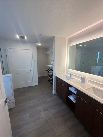 a large bathroom with a double vanity sink and a mirror