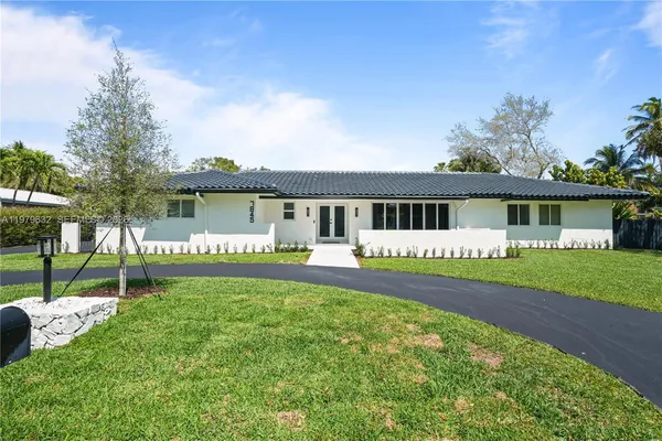 a view of a house with a yard and a patio