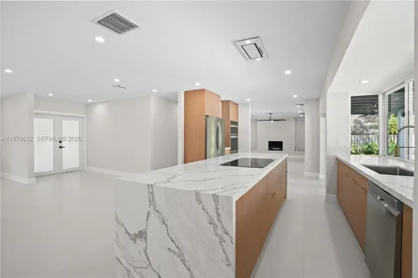 an empty room with windows and fireplace