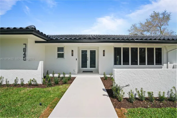 front view of a house with a garden