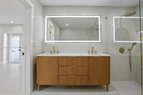 a bathroom with a bathtub sink and mirror