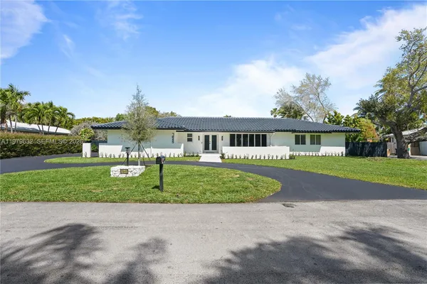 a front view of house with yard and green space