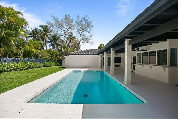 a view of a house with backyard and a sitting area