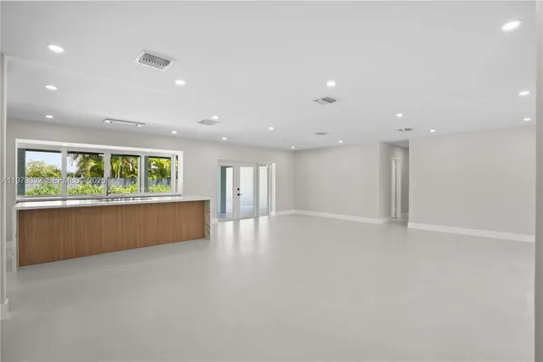 a kitchen with a sink and large window