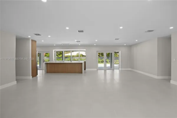 a large kitchen with stainless steel appliances kitchen island a large counter top and a stove top oven