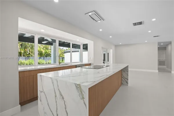 a kitchen with stainless steel appliances a refrigerator and a stove top oven
