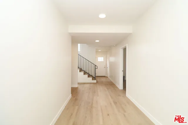 a view of a hallway with wooden floor
