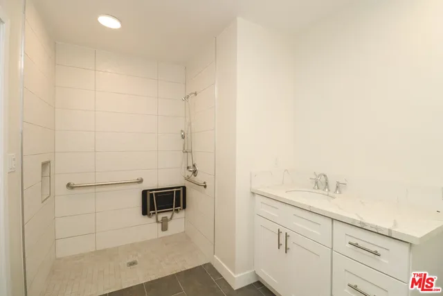 a bathroom with a shower sink and mirror