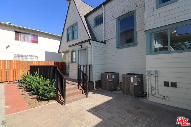 a view of a house with wooden deck
