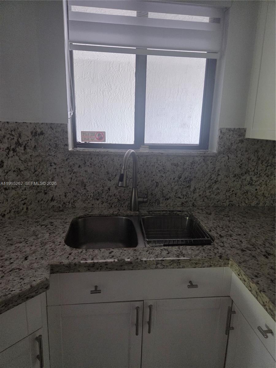 8365 Southwest 152nd Avenue, Unit 3 Miami, FL 33193 - Photo 15 of 25 a kitchen with a sink and cabinets