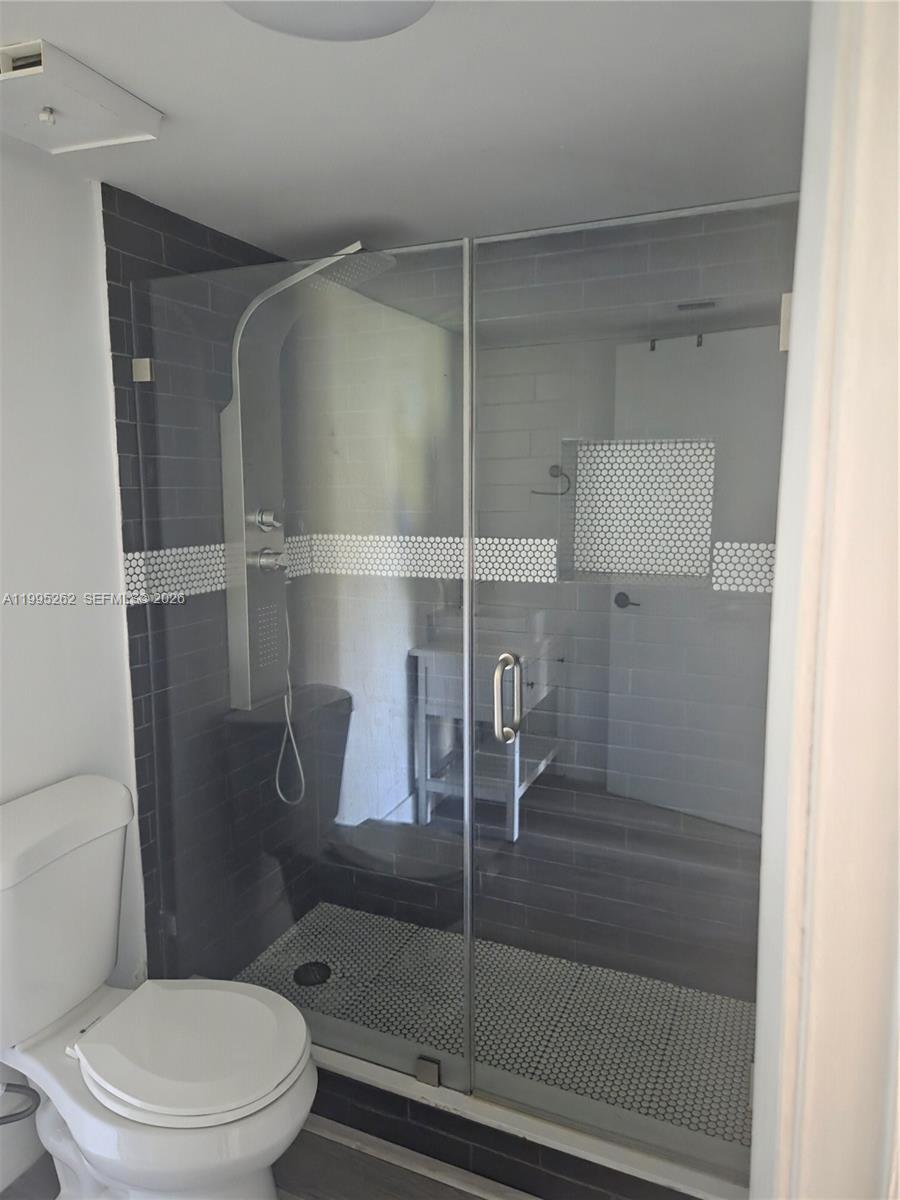 8365 Southwest 152nd Avenue, Unit 3 Miami, FL 33193 - Photo 16 of 25 a bathroom with a toilet and a shower