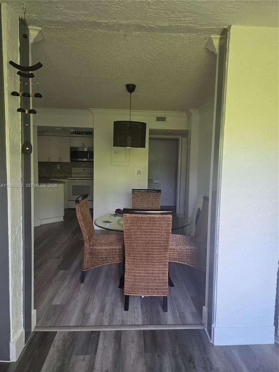 8365 Southwest 152nd Avenue, Unit 3 Miami, FL 33193 - Photo 2 of 25 a living room with couches chairs and closet with wooden floor