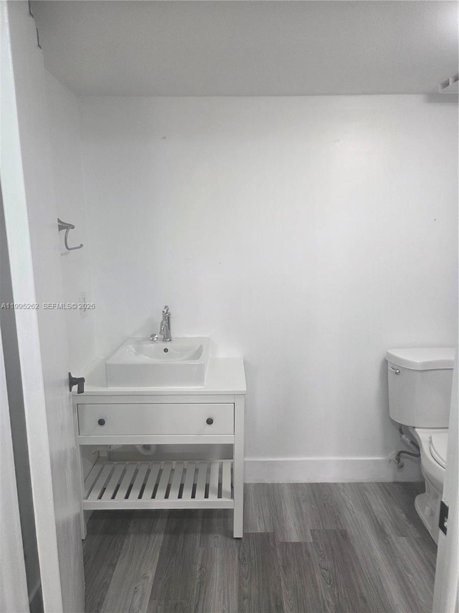 8365 Southwest 152nd Avenue, Unit 3 Miami, FL 33193 - Photo 23 of 25 a bathroom with a sink and a toilet