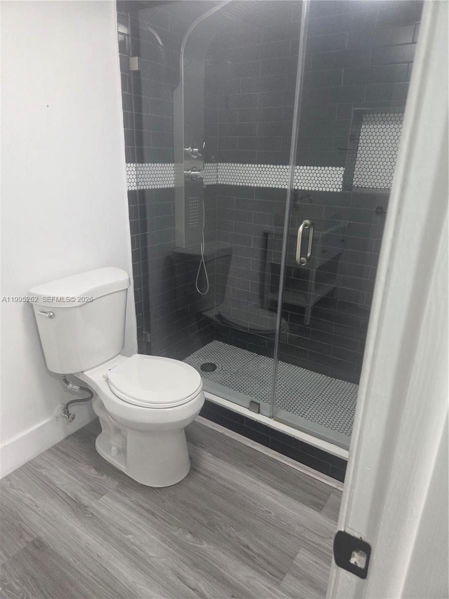 8365 Southwest 152nd Avenue, Unit 3 Miami, FL 33193 - Photo 24 of 25 a bathroom with a toilet and a shower