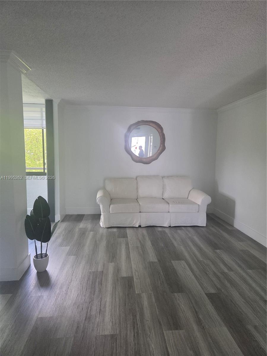 8365 Southwest 152nd Avenue, Unit 3 Miami, FL 33193 - Photo 5 of 25 a view of a livingroom with wooden floor and a window