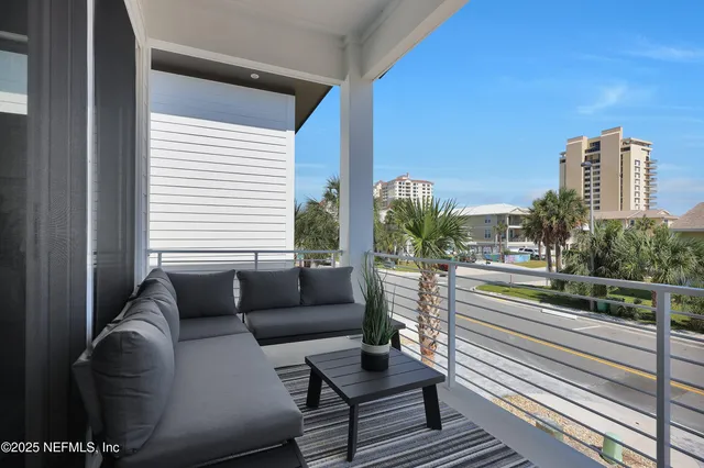 a balcony with furniture and a potted plant