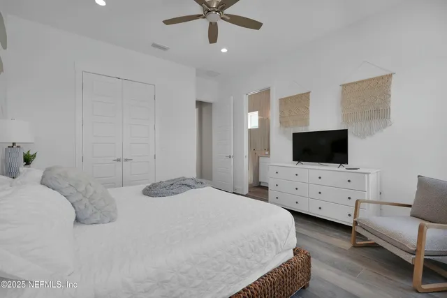 a bedroom with furniture and a flat screen tv