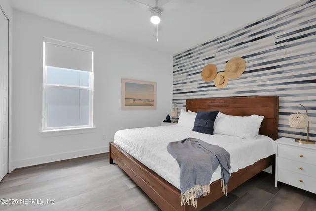 a bedroom with a bed lamp and window