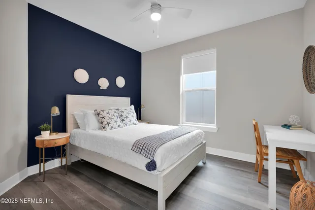 a bedroom with a bed and a table in it