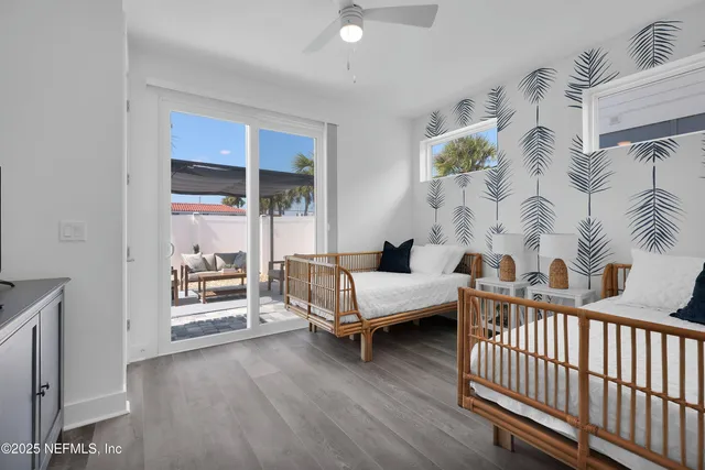a spacious bedroom with furniture and a window