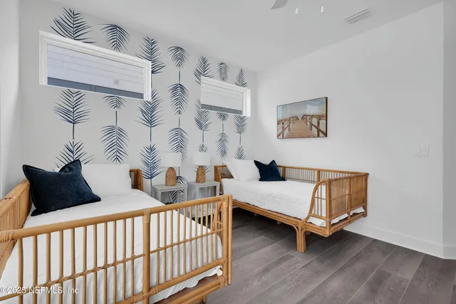 a bedroom with furniture and wooden floor