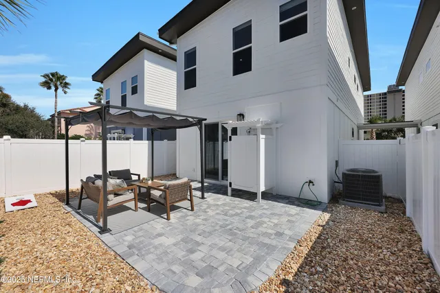 a view of a patio with table and chairs under an umbrella