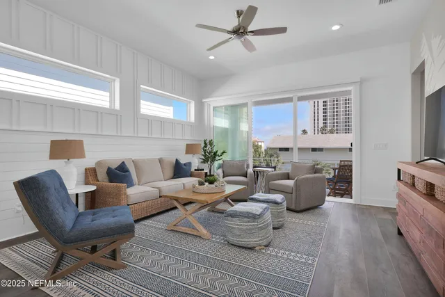 a living room with furniture a fireplace and a window