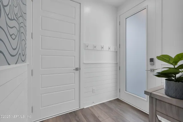 a view of entryway with wooden floor and stairs