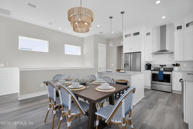 a view of a dining room with furniture wooden floor and chandelier