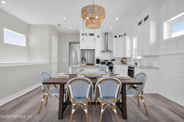 a view of a dining room with furniture window and wooden floor