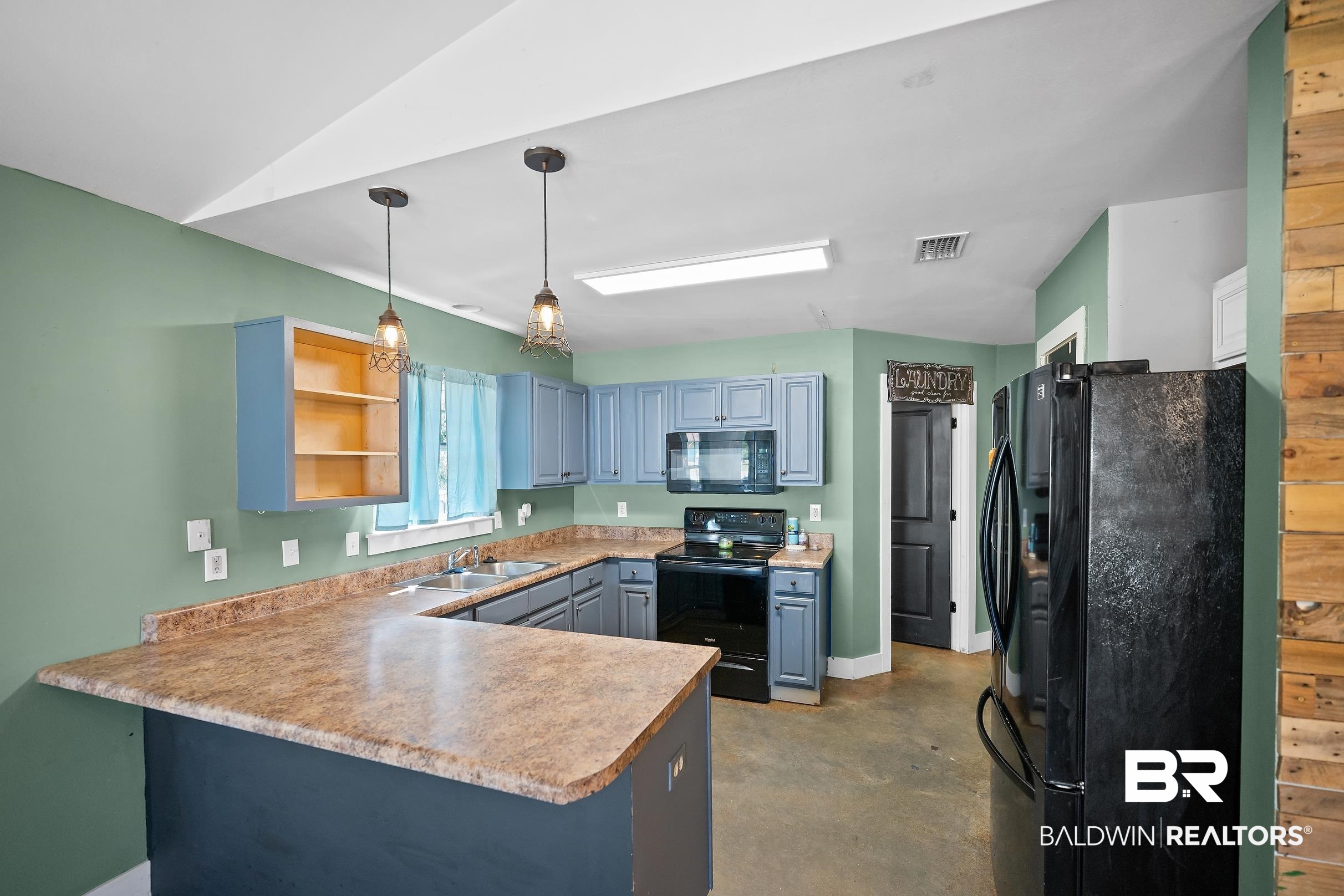 2000 Maria Lane Lillian, AL 36549 - Photo 29 of 35 Kitchen featuring black appliances, a peninsula, concrete floors, open shelves, and decorative light fixtures