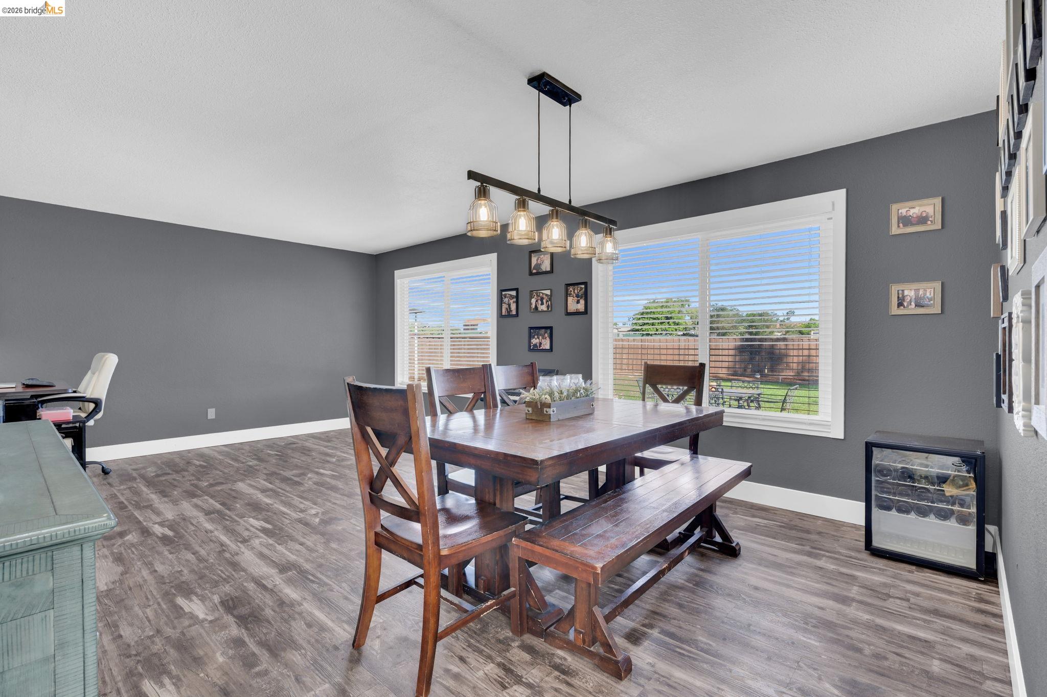 59 Old Stagecoach Road Brentwood, CA 94513 - Photo 13 of 70 Open-concept room featuring wood-finish flooring, two large windows, and a built-in beverage cooler