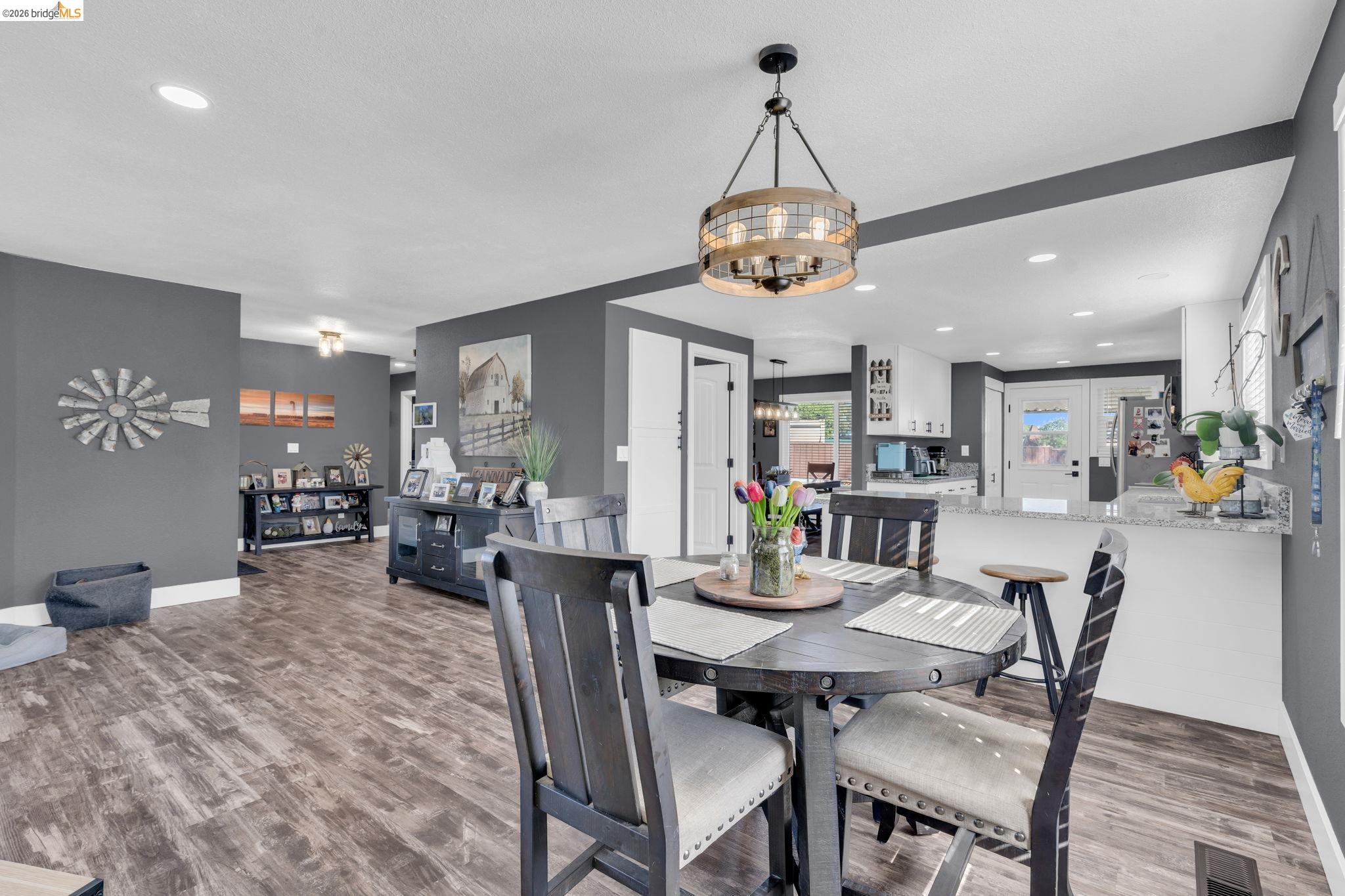 59 Old Stagecoach Road Brentwood, CA 94513 - Photo 18 of 70 Open-concept dining area featuring wood-finish flooring, a contemporary chandelier, recessed lighting, and a neutral color palette