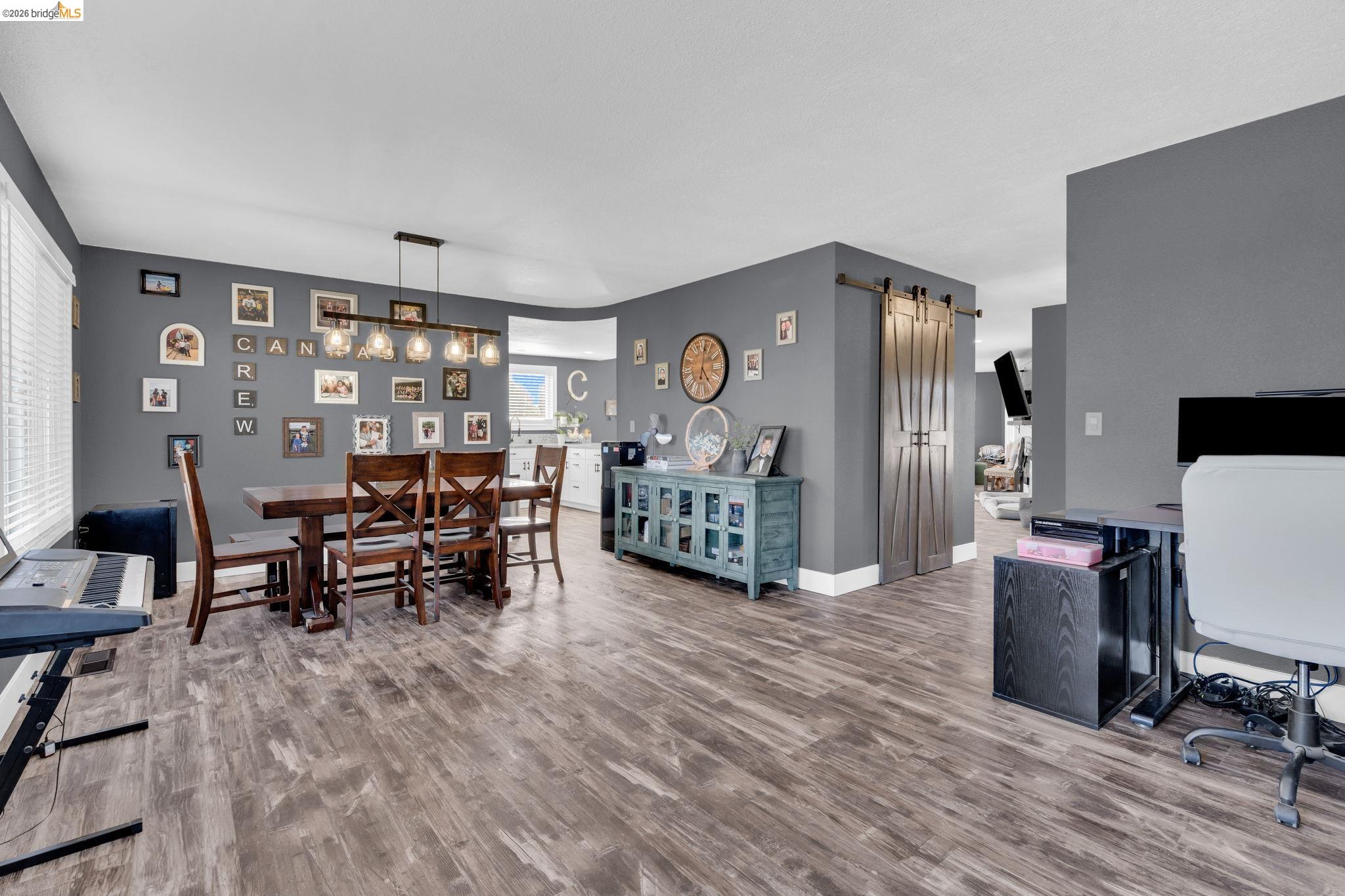 59 Old Stagecoach Road Brentwood, CA 94513 - Photo 23 of 70 Open-concept living space featuring wood-finish flooring, dark gray wall paint, and white trim
