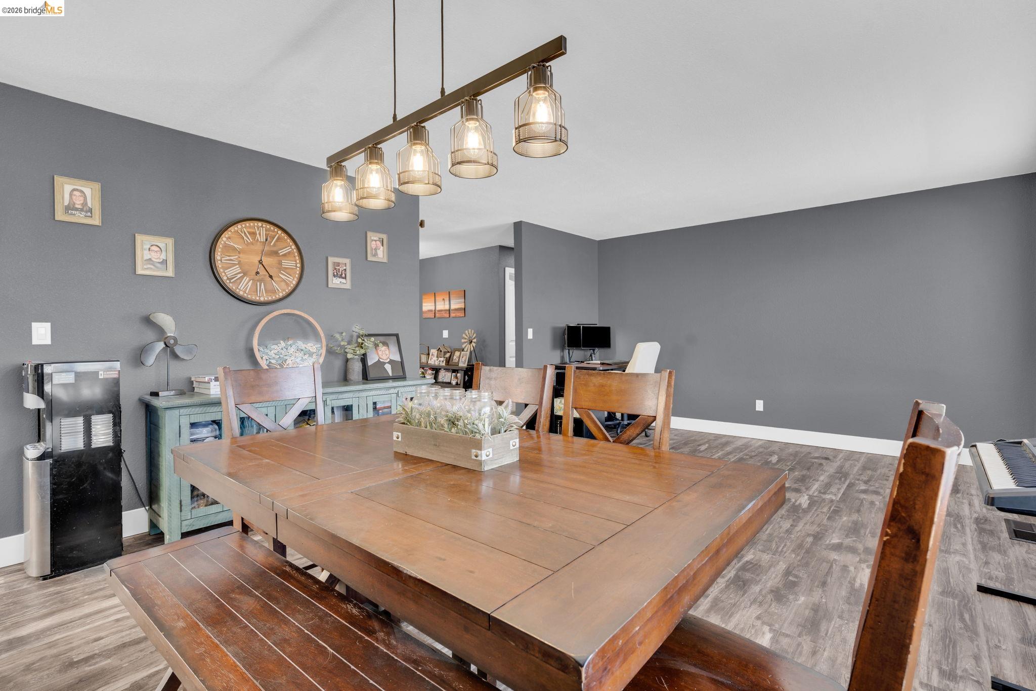 59 Old Stagecoach Road Brentwood, CA 94513 - Photo 24 of 70 Dining area featuring a linear multi-light fixture, wood-finish flooring, and a built-in buffet cabinet