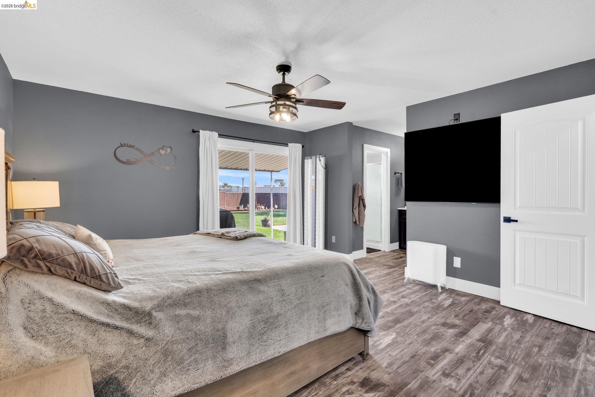 59 Old Stagecoach Road Brentwood, CA 94513 - Photo 27 of 70 Bedroom featuring wood-finish flooring, a ceiling fan with integrated lighting, and a sliding glass door providing direct access to the backyard