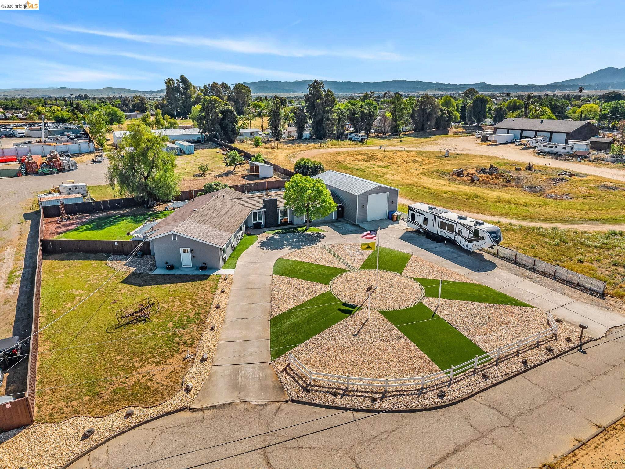 59 Old Stagecoach Road Brentwood, CA 94513 - Photo 3 of 70 Expansive driveway featuring a decorative compass rose design with gravel and artificial turf