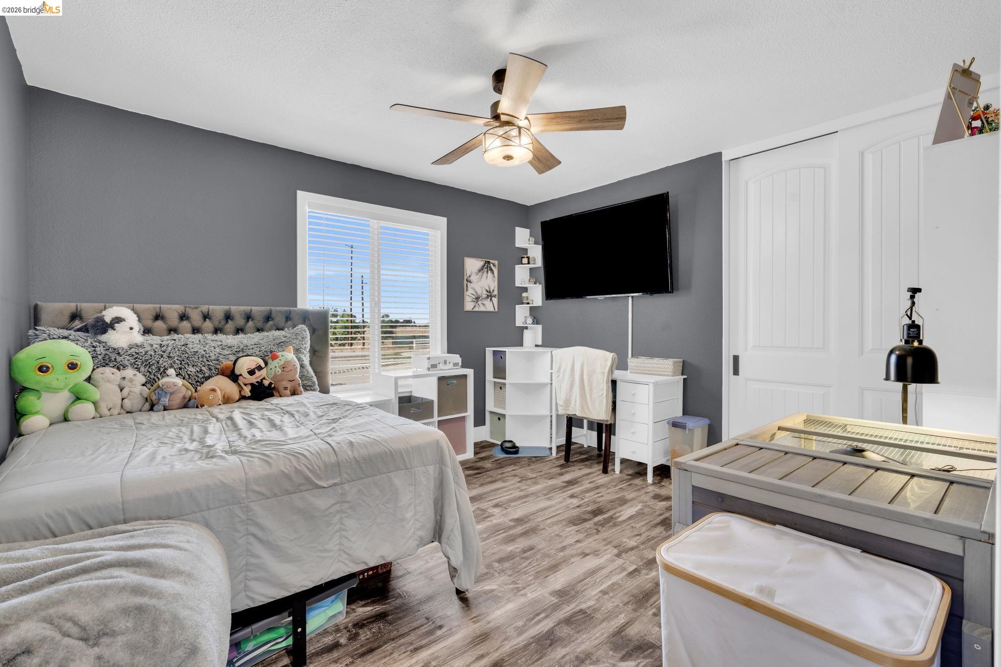 59 Old Stagecoach Road Brentwood, CA 94513 - Photo 38 of 70 Interior room featuring wood-finish flooring, a white-framed window with blinds, and a ceiling fan with light fixture