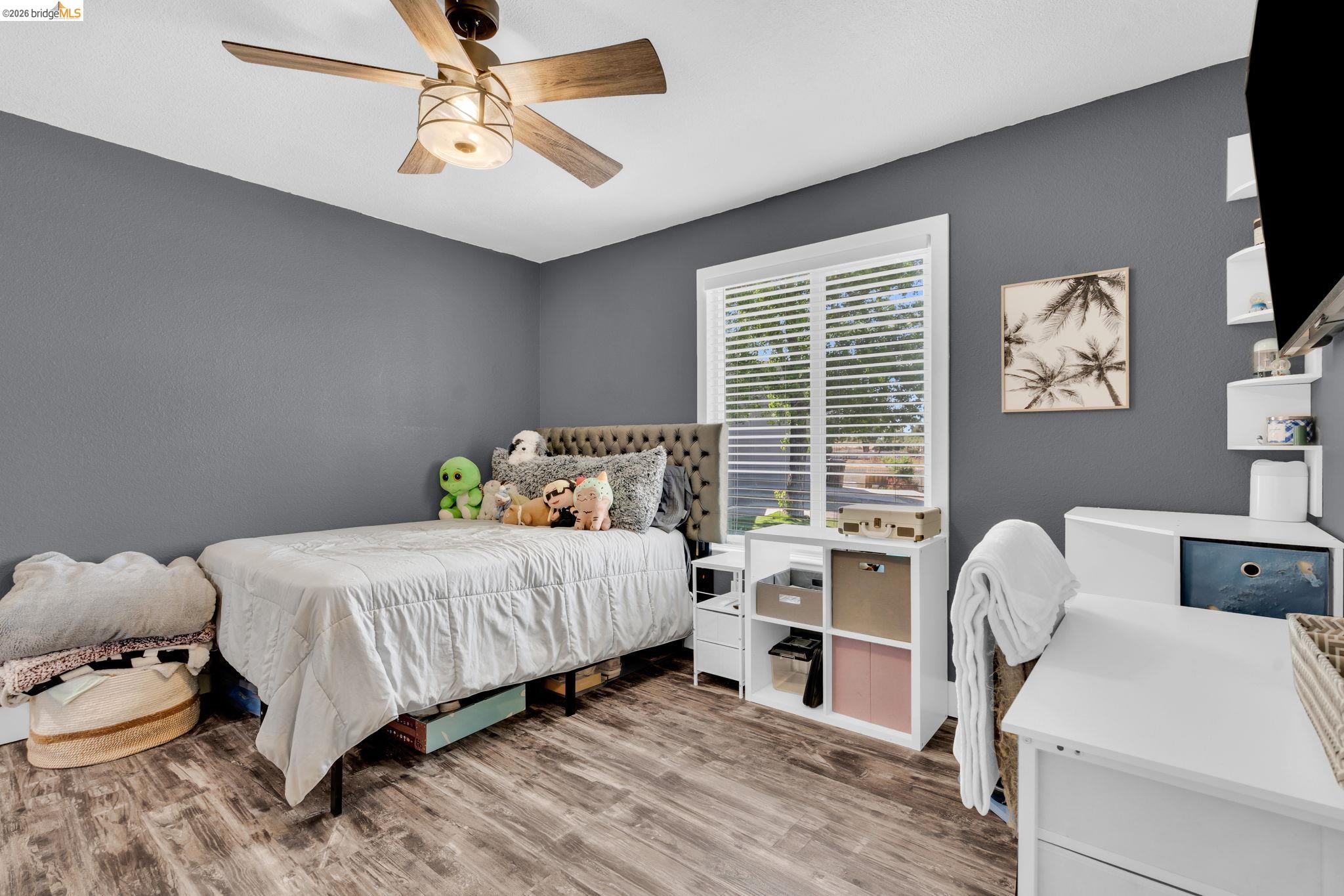 59 Old Stagecoach Road Brentwood, CA 94513 - Photo 39 of 70 Room featuring wood-finish flooring, a ceiling fan with integrated lighting, and a window with horizontal blinds