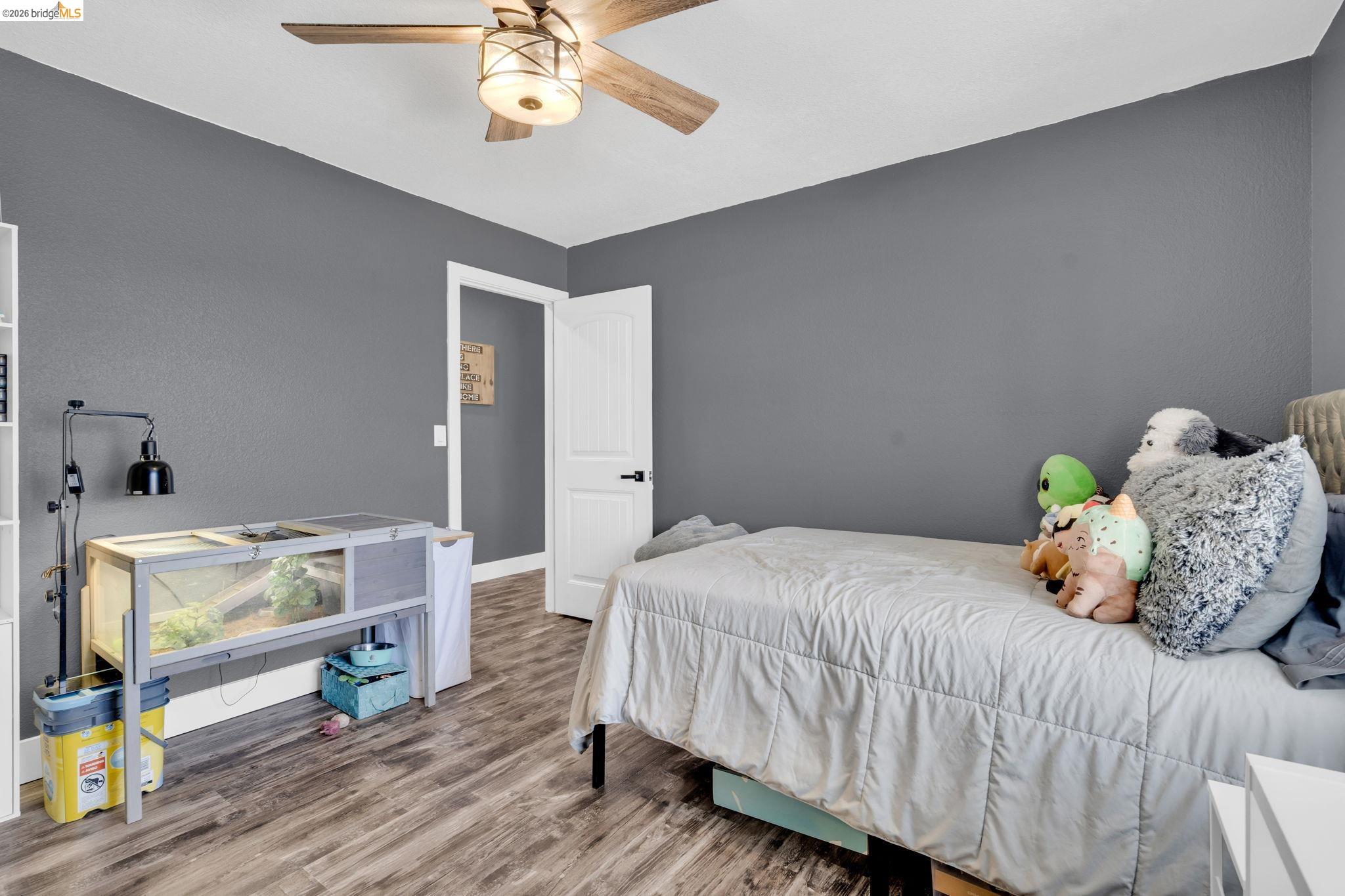 59 Old Stagecoach Road Brentwood, CA 94513 - Photo 40 of 70 Room with wood-finish flooring, a ceiling fan with integrated lighting, and a white paneled door