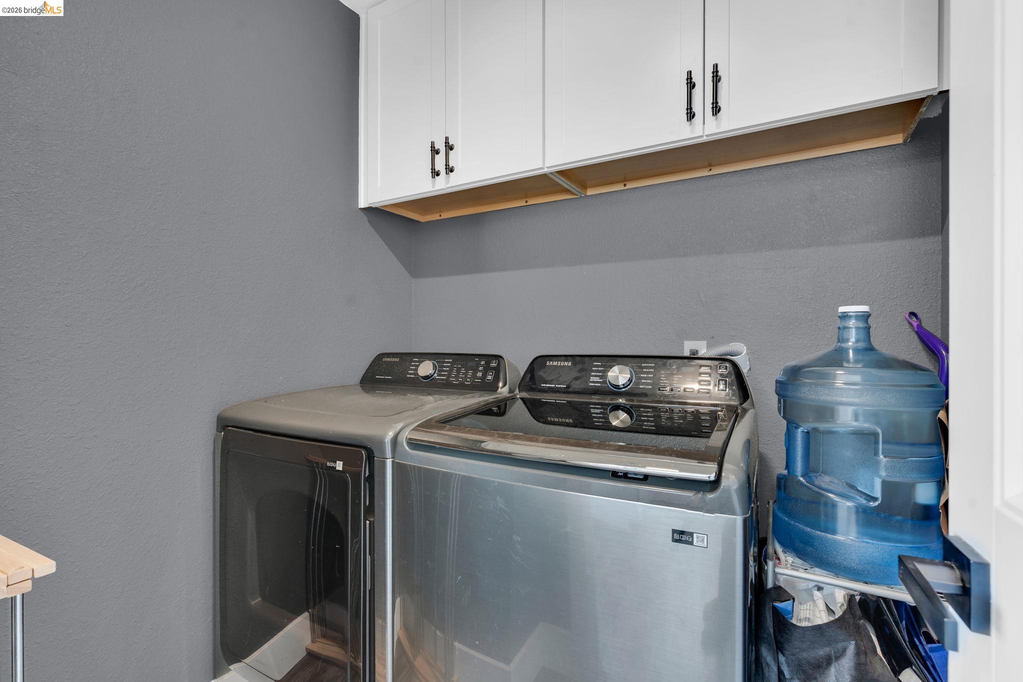 59 Old Stagecoach Road Brentwood, CA 94513 - Photo 41 of 70 Laundry area featuring overhead white cabinetry with black hardware
