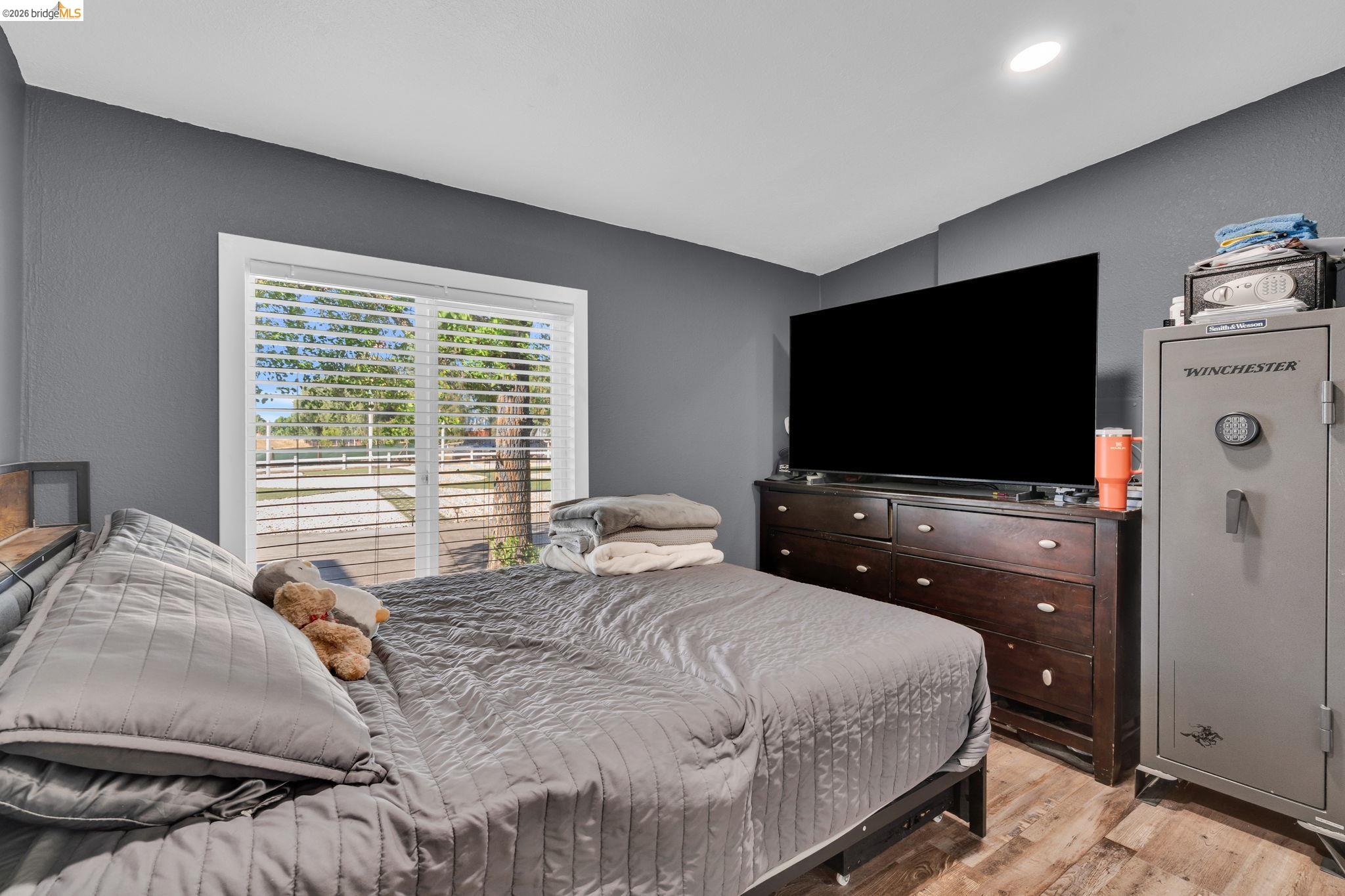 59 Old Stagecoach Road Brentwood, CA 94513 - Photo 46 of 70 Bedroom featuring wood-finish flooring and a large window with blinds