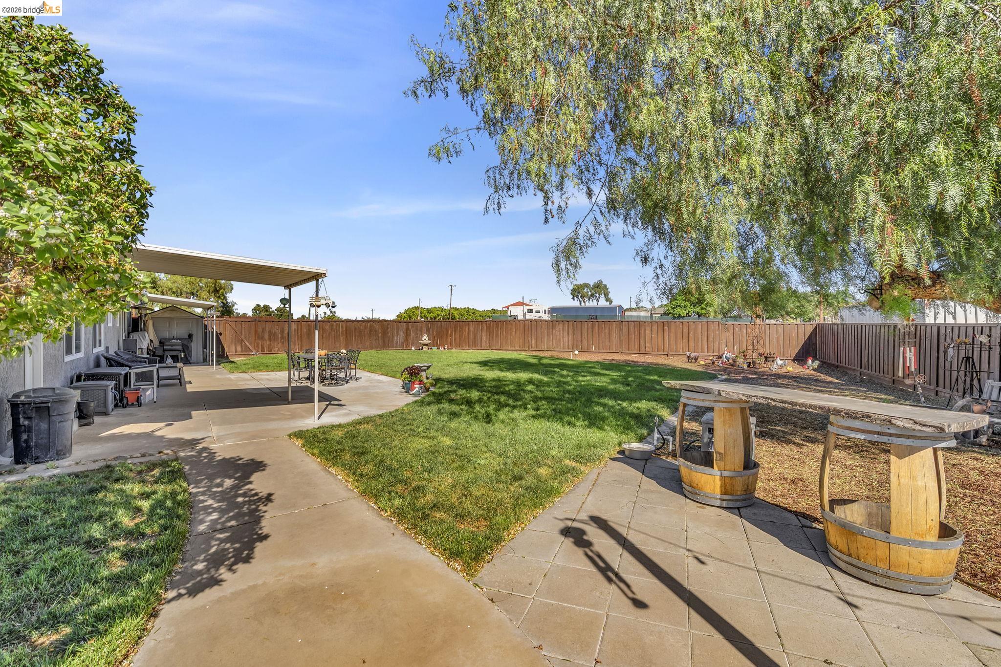 59 Old Stagecoach Road Brentwood, CA 94513 - Photo 53 of 70 Expansive backyard featuring a manicured lawn, concrete patio, and a covered patio area
