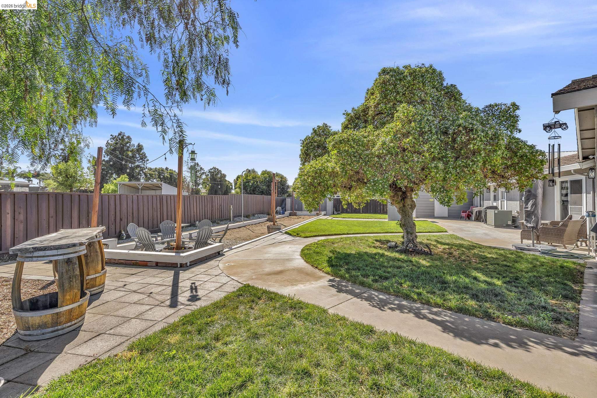 59 Old Stagecoach Road Brentwood, CA 94513 - Photo 55 of 70 Outdoor lounge area with a built-in fire pit, surrounded by a wood privacy fence