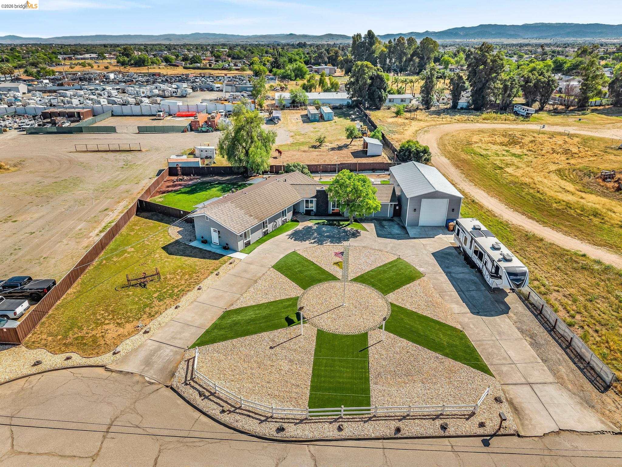 59 Old Stagecoach Road Brentwood, CA 94513 - Photo 6 of 70 Expansive property featuring a single-story residence, a large detached garage/shop, and a circular gravel driveway with integrated lawn sections