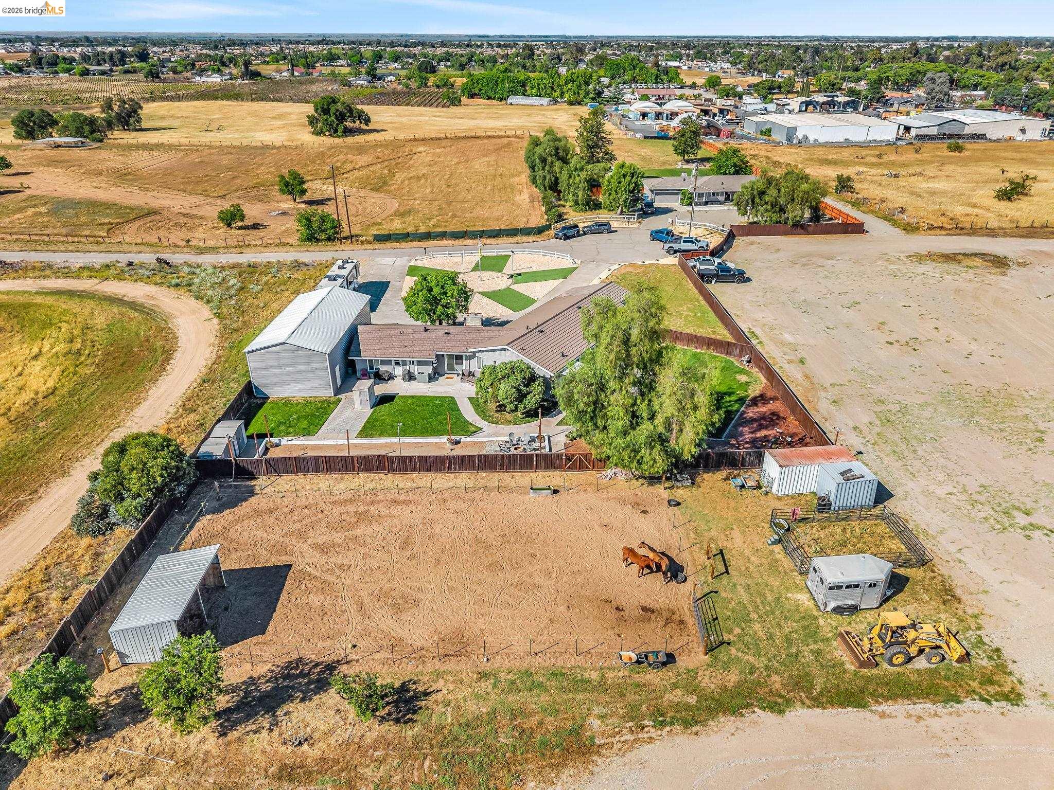 59 Old Stagecoach Road Brentwood, CA 94513 - Photo 64 of 70 Expansive property featuring a single-story residence, a large metal outbuilding, fenced paddocks, and a manicured lawn area